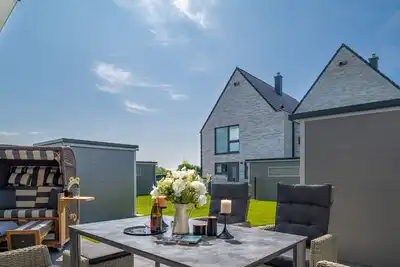 Image de Ferienhaus Wellenrauschen - Terrasse, Balkon, Sauna, Kamin, Nordsee- & Strandnah