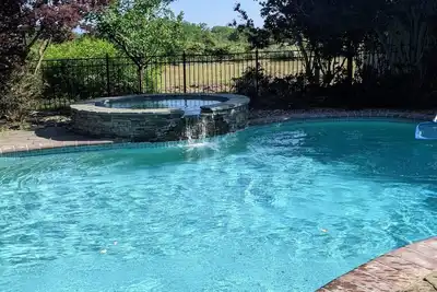 Image de Comfortable, bright home with heated pool/spa, large deck, and yard.