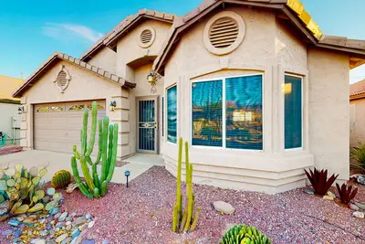 Image de Southwestern home with colorful patio, sparkling pool, grill & dart board