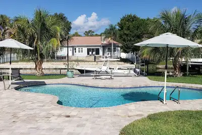 Image de Luxury waterfront pool home with dock.