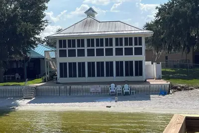 Image de Lakefront home with white sand beach and private boat dock on Crooked Lake.