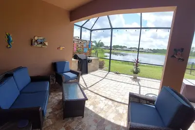 Image de Lake view home with a screened outdoor entertainment area.